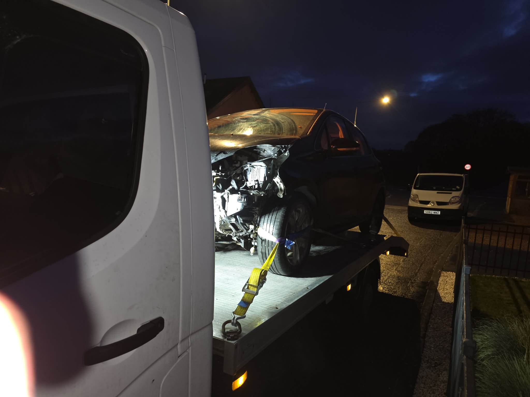 Damaged vehicle loaded on GTT flatbed for scrap collection