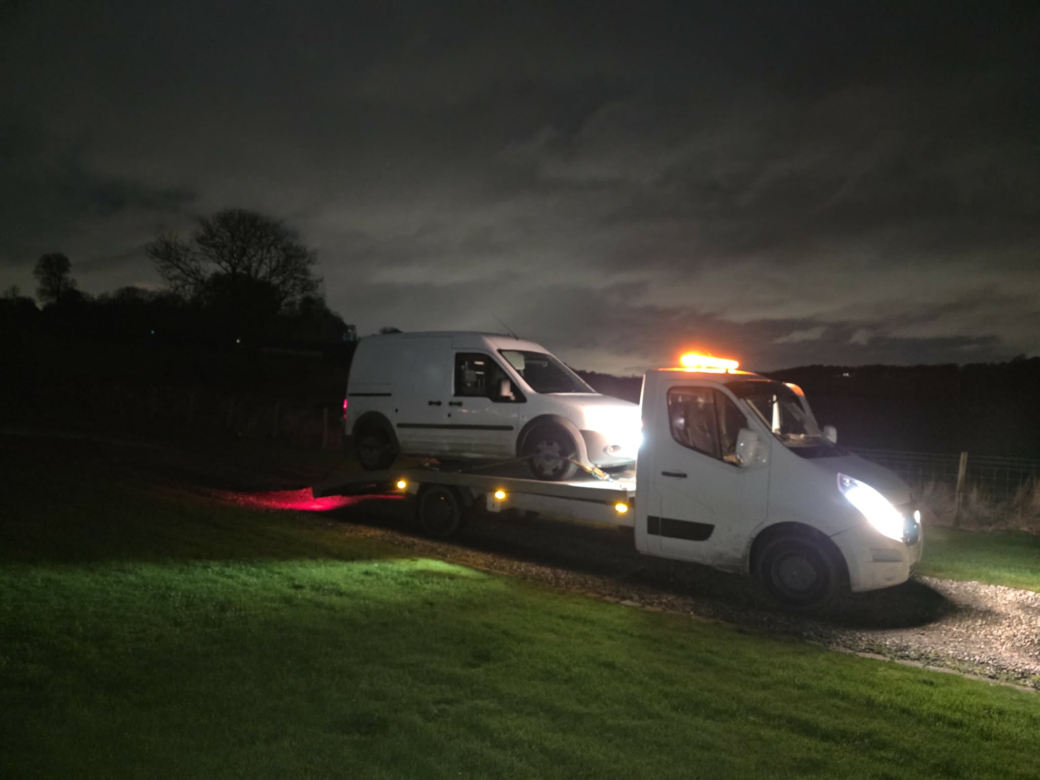 Night-time recovery of a white van from a grass verge