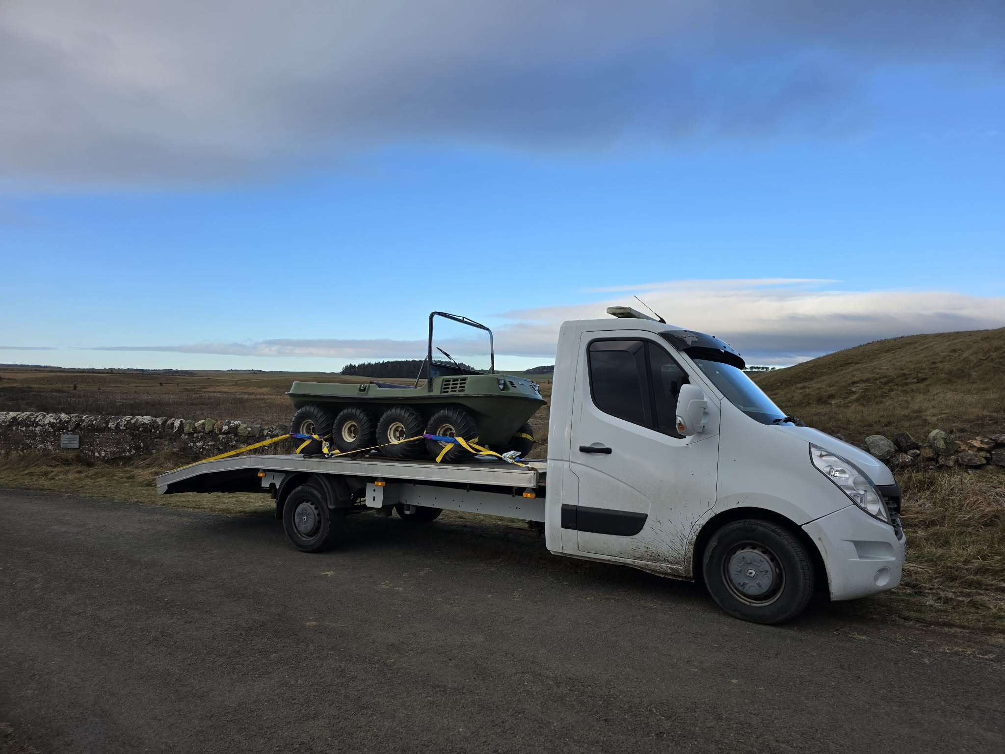 GTT Recovery flatbed truck on a Scottish highland road with a vehicle loaded for transport